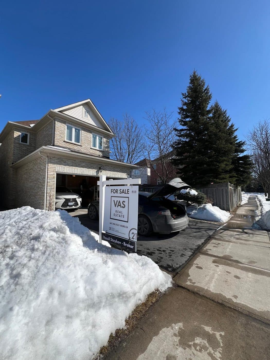 A VAS Real Estate for sale sign outside a Markham home